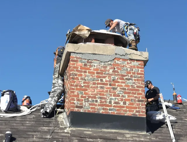 Matthews Chimney Sweep installing a custom chimney crown in Matthews, NC