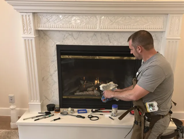 Matthews Chimney Sweep performing fireplace maintenance in Matthews, NC